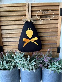 some potted plants are sitting in front of a wooden sign that says pde pattern