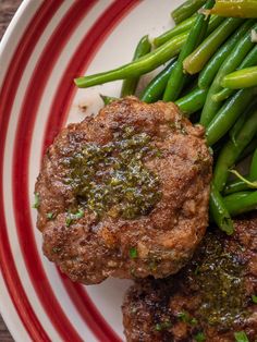 some meat and green beans on a plate