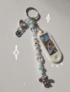 a keychain with an image of jesus on it and beads attached to it