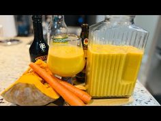 there are carrots, orange juice and bottles on the counter