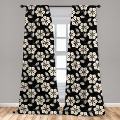 a black and white curtain with flowers on it