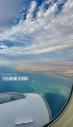 the view from an airplane window looking out at the ocean and clouds in the sky