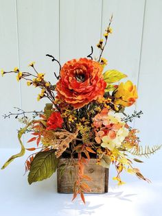 an arrangement of flowers in a wooden vase