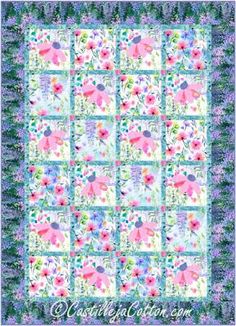 a quilt made with pink and blue flowers on a green background, the pattern is very colorful