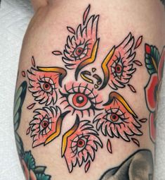 a close up of a person's leg with tattoos on it and an owl