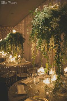 the table is set with candles and greenery