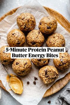 chocolate chip muffins on parchment paper next to a spoon and bowl of peanut butter