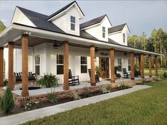 a white house with porches and chairs on the front