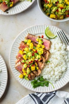 three plates with meat, rice and veggies next to a bowl of salsa