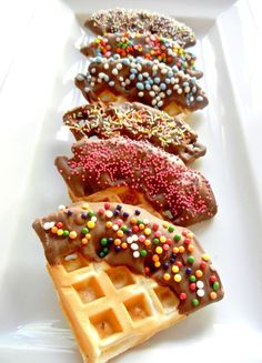 a white plate topped with waffles covered in sprinkles