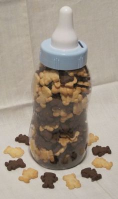 a glass bottle filled with dog treats on top of a table