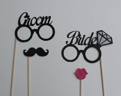 two wedding cake toppers with the word groom and bride spelled in black on them