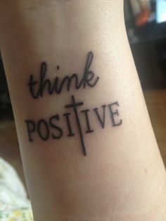 a tattoo that says think positive on the side of someone's leg with words written below it