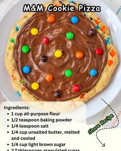 a cookie with chocolate frosting and m & m candies on top is shown