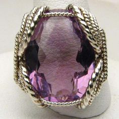 "Wire Wrapped Sterling Silver Handmade Genuine Faceted Amethyst Ring 25x18mm 12+ct View more Amethyst jewelry in our shop https://www.etsy.com/shop/JandSGems?ref=hdr_shop_menu&search_query=amethyst Sizing and shipping is ALWAYS FREE with a 14 day \"No Questions Asked\" return policy. This ring is made with real gems. I made it myself, so if you see a setting you like and want a different gem in it, I can put in another one as they are not finished. I can probably do it for the same price or Elegant Large Stone Amethyst Ring, Exquisite Silver Amethyst Ring, Elegant Purple Amethyst Ring With Large Stone, Elegant Silver Amethyst Ring With Large Stone, Elegant Faceted Purple Rings, Elegant Purple Faceted Rings, Handmade Purple Amethyst Ring For Formal Occasions, Exquisite Silver Amethyst Gemstone Ring, Unique Purple Amethyst Ring With Accent Stones