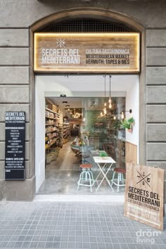 an entrance to a restaurant with tables and chairs