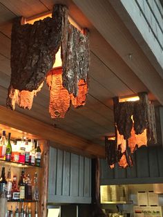 several lights hanging from the ceiling in a bar