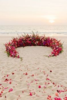 a circular arrangement of flowers on the beach