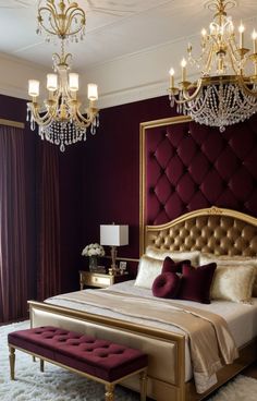 a bedroom with a large bed and chandelier