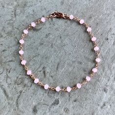 Rose Quartz Bracelet in rose gold fill This dainty circlet features wire-wrapped pink quartz beads. These stones absolute glow! Extra lovely in the rose gold finish - the colors are so complementary. With 14K rose gold-filled clasp components. Boho, graceful, and utterly charming. Also available in ANKLET sizes Rose Pink Quartz - faceted rondelles, approximately 3mm Stones are wrapped in rose gold-plated brass wire Bracelet pictured measures 7 inches in length Fastens with rose gold filled lobst Bracelet Rosary, Minimal Bracelet, Bracelet Rose Gold, Rose Quartz Bracelet, Rose Quartz Necklace, Dainty Bracelet, Moonstone Bracelet, Rosary Chain, Boho Bracelet