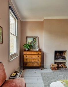 a living room filled with furniture and a fire place next to a painting on the wall