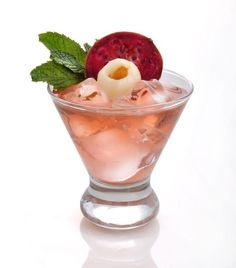 a glass filled with ice and garnish next to a raspberry on top