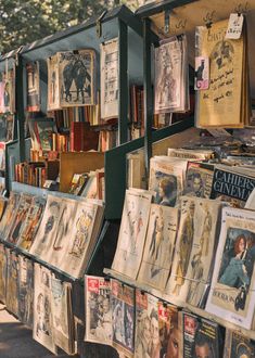 an outdoor book stand with many books on it