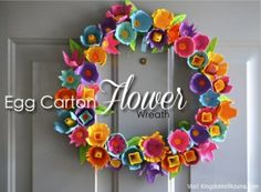 an egg carton flower wreath hanging on a door with the words egg carton flowers