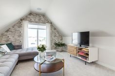 a living room filled with furniture and a flat screen tv