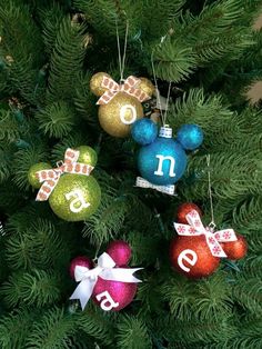 mickey mouse ornament ornaments hanging from a christmas tree with the number one on them