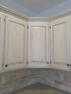 a kitchen with white cabinets and granite counter tops