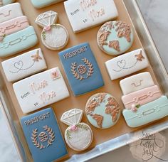 a box filled with cookies decorated like suitcases and travel related items on top of each other