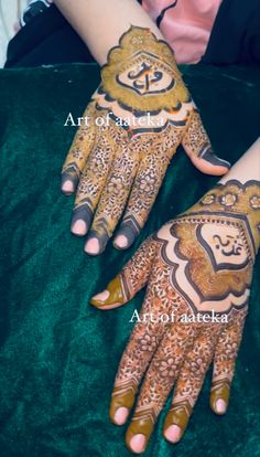 two hands with henna designs on them, one is painted gold and the other is brown