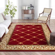 a living room with white furniture and red rug