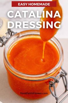 homemade catalina dressing in a glass jar being drizzled with orange juice