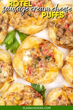 mini pizzas filled with cheese and meat are on a white platter, surrounded by parsley