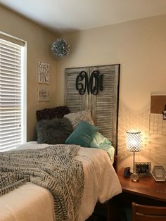 a bed sitting next to a window in a bedroom