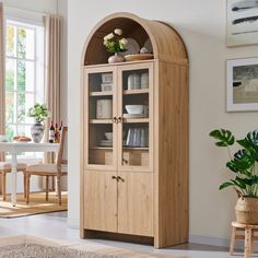 a wooden cabinet with glass doors in a living room