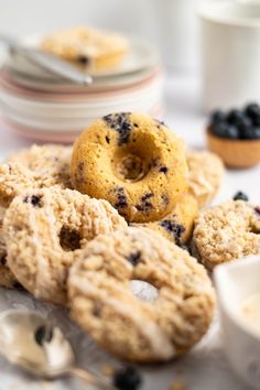 blueberry muffins and other pastries on a table