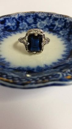 "Thanks for shopping our vintage estate store. We tend to sell well below wholesale and truly hope you enjoy all of our items. Many of the items are one of a kind, so please enjoy scrolling through the pictures and hopefully something will catch your eye. Black spots are from camera. Nice estate sterling silver 925 Blue 3ct Sapphire color stone filigree ring. This is a custom ring from our shop, meaning we set the gem into the setting. Gem is synthetic or created. Ring size: please select size S Vintage Sterling Silver Filigree Ring, Vintage Sapphire Jewelry For Formal Occasions, Vintage Sterling Silver Filigree Ring Collectible, Vintage Sterling Silver Filigree Ring Gift, Vintage Sterling Silver Filigree Ring As Gift, Vintage Filigree Ring Stamped 925 As Gift, Vintage Blue Ring Jewelry, Vintage Blue Rectangular Jewelry, Antique Blue Sapphire Collectible Ring