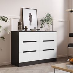 a white dresser with black drawers in a living room