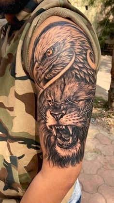 a man's arm with an eagle and lion tattoo on it