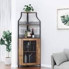 a living room filled with furniture and a tall wooden cabinet next to a couch in front of a window