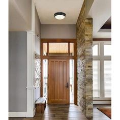 an entry way with a wooden door and brick pillars