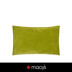 a green pillow with the name macy's on it