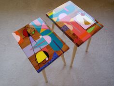 two colorful tables sitting on top of a carpeted floor