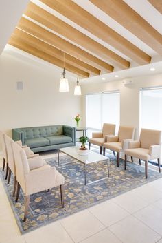 a living room filled with lots of furniture and a rug on top of a floor