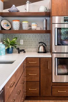 a kitchen with wooden cabinets and stainless steel appliances, including an appliance that is built into the wall