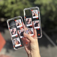 a person holding up two cell phones with pictures on them and hearts attached to the back