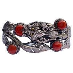 This is a wonderful antique Chinese Dragon Bracelet in Sterling Silver and adorned with beautiful Coral cabochons. The silver work is extraordinary with a fantastic Dragon motif that extends throughout the bracelet. The bracelet is accented by four Coral cabochons. The dragon has fabulous high relief details that create great dramatic effect. The bracelet opens to fit over the wrist and has a screw type closure. The interior of the bracelet is 7 inches (18 cm) around. The top of the bracelet is Dragon Chino, Dragon Motif, Dragon Bracelet, Dragon Jewelry, Silver Dragon, High Relief, Silver Work, Chinese Dragon, Bracelet Sterling Silver